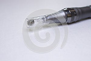 Dermis stamp electric pen. Dermapen. Needle mesotherapy treatment. photo