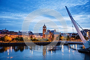 Derry, Ireland. Illuminated Peace bridge in Derry Londonderry, City of Culture, in Northern Ireland with city center at