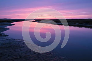 Pink And Purple Sunset Reflecting In Calm River Estuary
