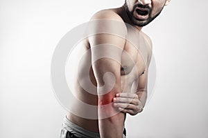Desaturated male body showing elbow injury