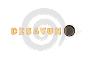 Desayuno with alphabet letters cookies and a cup of coffee on a white background photo