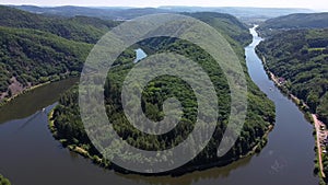 Descending aerial shot of saar loop river in Germany during sunny day