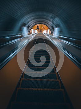 Descending the escalator stairs in the subway