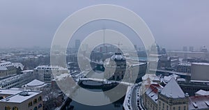 Descending footage of landmarks in city centre. Winter aerial shot of Bode Museum on Spree river waterfront. Berlin