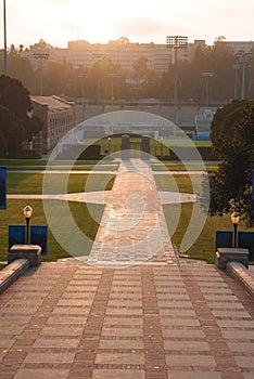 Descending stairs to stadium, sun setting on campus.