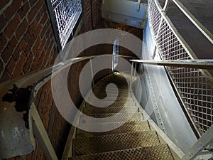 Descending weather-beaten spiral staircase photo