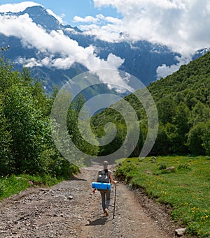 She descends from the mountain on forest path