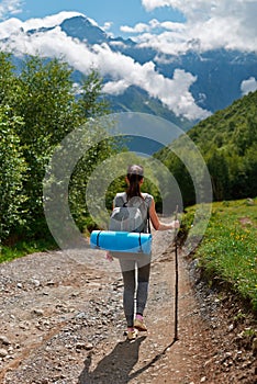 She descends from the mountain on forest path