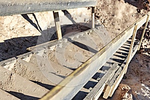 Descent into a deep pit during the construction of the building. Safety in construction. Ladder for descending to reinforced