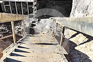 Descent into a deep pit during the construction of the building. Safety in construction. Ladder for descending to reinforced