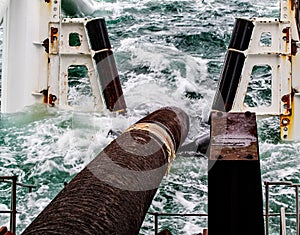 Descent of the pipeline to a bottom exhausting with the pipelaying barge. Installation of the underwater gas pipeline