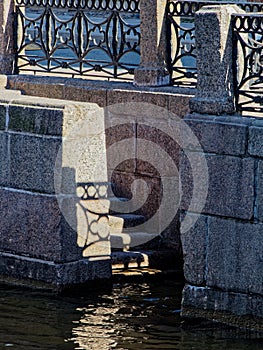 Descent to the water in the granite embankment of the Moika river.