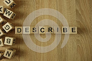 Describe word from wooden blocks photo