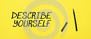 DESCRIBE YOURSELF sign with black marker on a yellow background. With copy space ready for your text