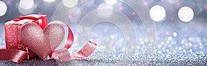Romantic Valentine\'s Day Decoration: Ribbon Shaped Hearts on Shiny Background photo