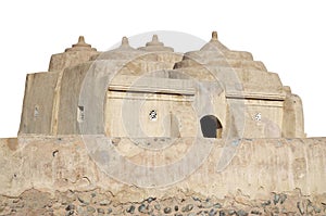 Desert barn built of clay and rough sandstone isolated