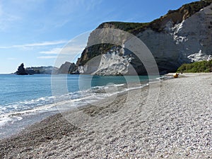 Desert beach with white cliffs looking on the sea to Ponza in Italy.