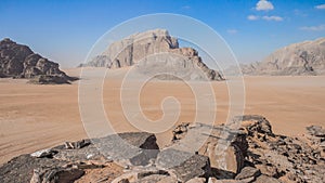 desert beautiful landscape sand valley in center and dry picturesque rocks foreground and background natural frame composition