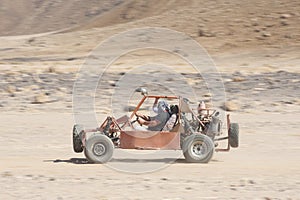 Desert buggy racing across ground