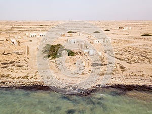 The desert at coast of Persian Gulf. Ruined abandoned traditional arab town Al Jumail, Qatar. Middle East.