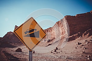 Desert crests following big slope car signal in Atacama, Chile