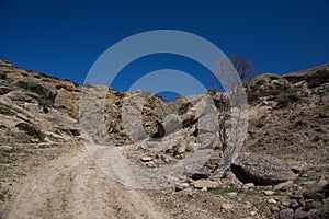 Desert dirt road through caucasus