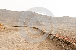 Desert Dirt Road in the Morning with Mountains in Background