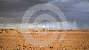 the desert is filled with dirt and storm clouds overhead it