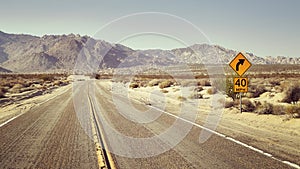 Desert highway with speed limit sign, USA.