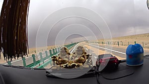 Desert highway view through truck windshield