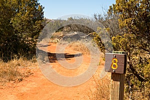 Desert hiking trail and distance marker sign post