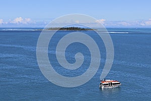 Desert island and a boat, south Pacific