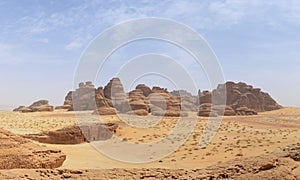 desert landscape - basalt stone mountain / rocks and tomb entrance