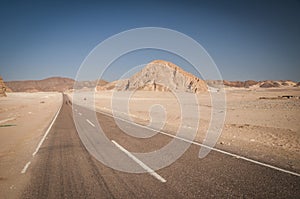 Desert landscape with blue sky and sun and road