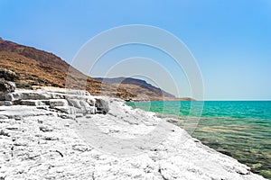 Desert landscape of Dead Sea coastline with white salt, Jordan, Israel.