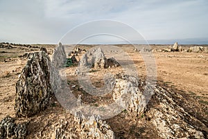 Desert landscape with rock formations of sharp rocks and dry land