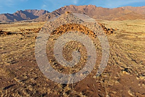 Desert landscape with rocks and arid grassland, Brandberg mountain, Namibia