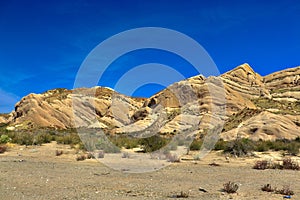 Desert landscape transitioning into dry rocky mountains