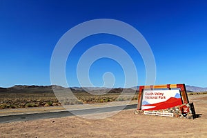 Desert Landscape with Western Entrance Sign of Death Valley National Park, California, USA