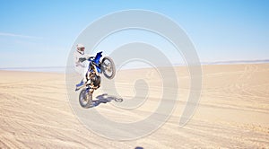 Desert, motorbike and sports person travel, journey and driving on off road adventure, freedom and balance on bike