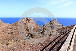 Desert mountain landscape surrounding Entallada lighthouse overlooking the ocean, Fuerteventura, Canary Islands, Spain, Atlantic,