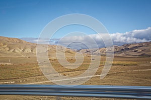 Desert-mountainous terrain . Blue sky with many white clouds. Desert and Mountain Landscape with Azerbaijan . Desert and blue sky