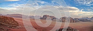 Desert panorama under blue sky with white clouds