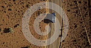 Desert road, car driving and aerial view with drone in Arizona with landscape and countryside. Street, nature and