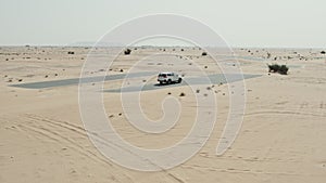 Desert road with sand dunes