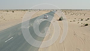 Desert road with sand dunes