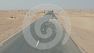 Desert road with sand dunes