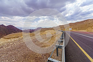 Desert road, with a warning sign