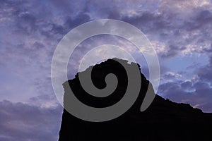 Desert Rock Pinnacle Silhouette Against Blue and Purple Sky