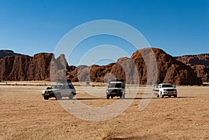 Desert safari, cars standing in front of rock formation, Chad